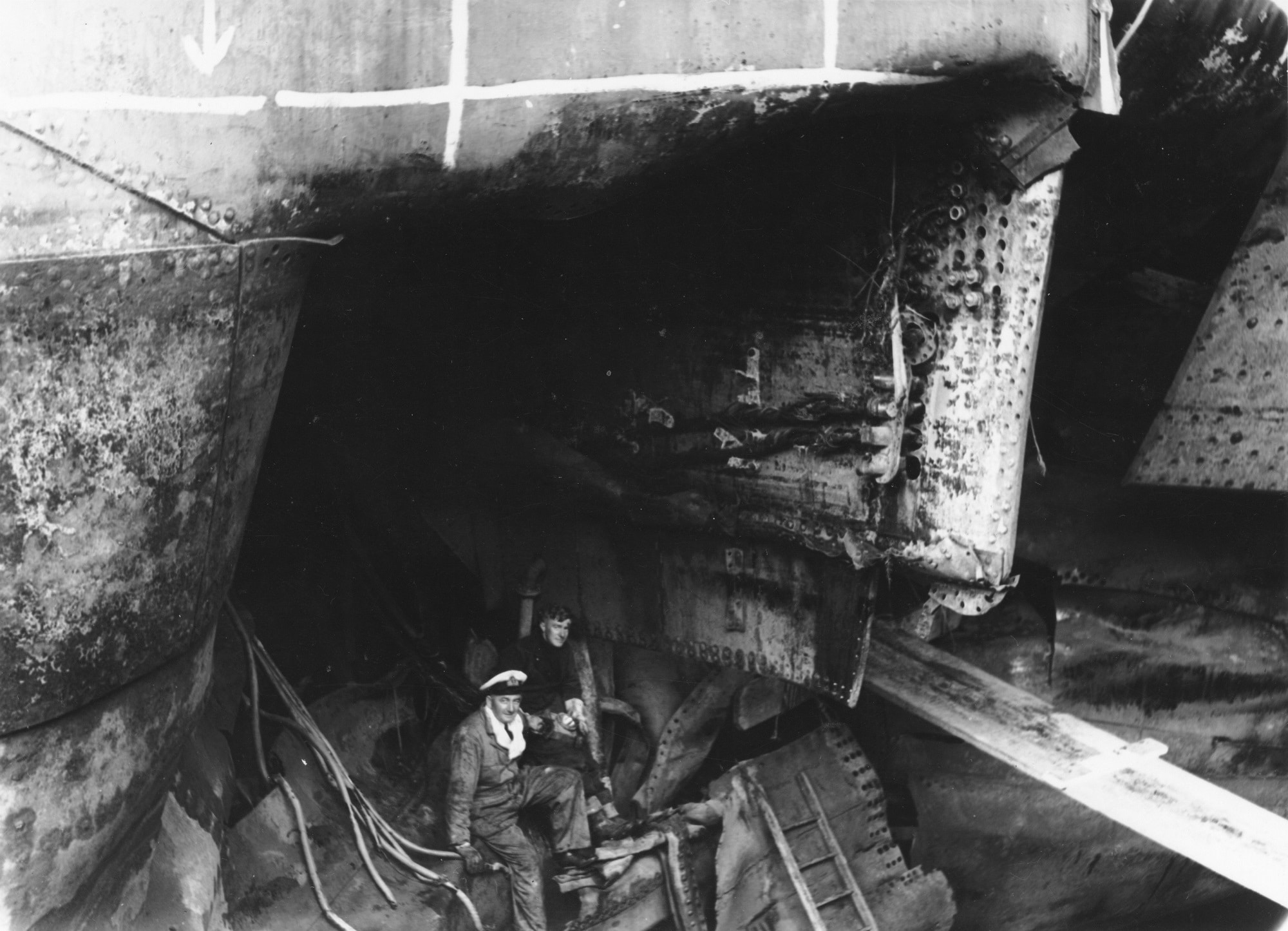 Inspecting torpedo damage on the HMNZS Leander