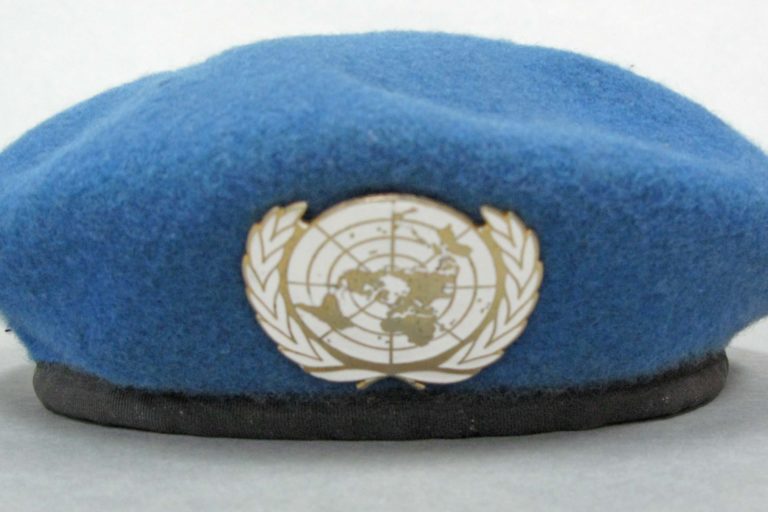 Object No: CEK 0001 Blue United Nations beret with white UN badge. Issued to LT CDR Campbell, Officer in Charge of UNTAC (United Nations Transitional Authority in Cambodia) Team One.