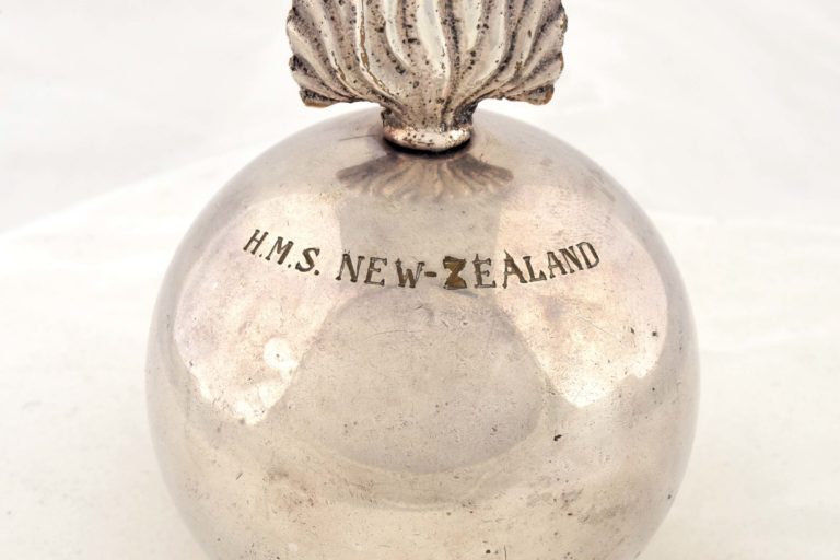 Silver lighter shaped like a grenade. Engraved are the words ‘HMS NEW ZEALAND‘.