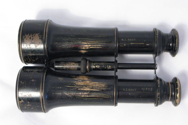 Binoculars complete with brown leather case. Glasses have no manufactures mark but each barrel is marked: ‘NZ Navy’. Case was made by George Bussey & Co. Ltd 1917.
