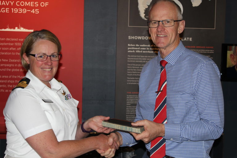 David Wright - Navy Museum Director accepting a donation from Commander (now Captain) Lisa Hunn