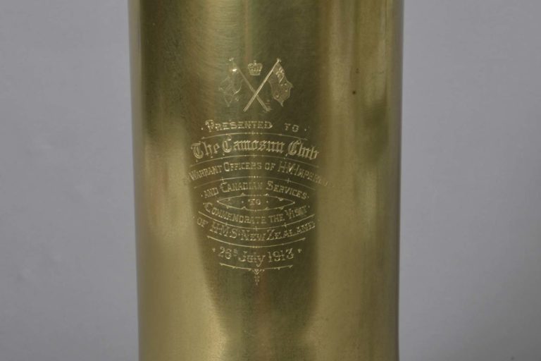Brass presentation bell with clapper. Bell given to the Camosun Club of Victoria, British Colombia, by the Warrant Officers of HMS New Zealand. Inscribed on the bell are the words: ‘Presented to The Camosun Club by Warrant Officers of HM Imperial and Canadian Services to Commemorate the Visit of HMS New Zealand 26th July 1913’.